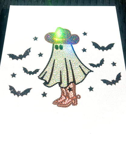 Rhinestone-art ghost with hat and boots surrounded by bats on a white background.