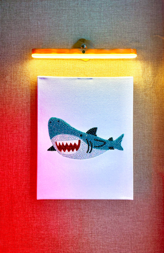 Rhinestone-bedazzled canvas wall art of a cartoon shark.