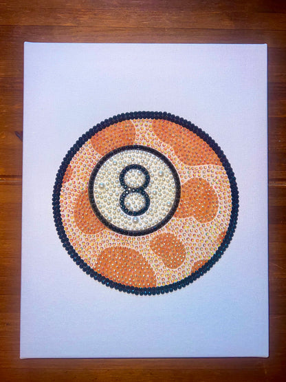 A hand-bedazzled canvas art piece 8-ball featuring a cowprint pattern, with a white background.